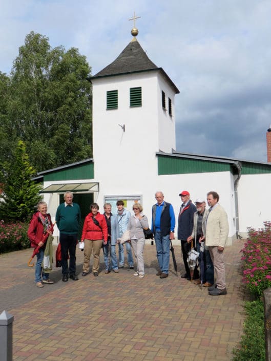 Heimatfreunde aus Lengerich während des Ortsrundganges vor der evangelischen Kirche
