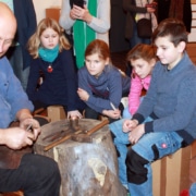 Schmied und Metallkünstler Olaf Hannemann erklärt den Kindern die Technik der Metallbearbeitung (Foto: Babett Wiechmann)